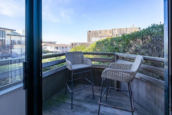 a view of a chairs and table in the balcony