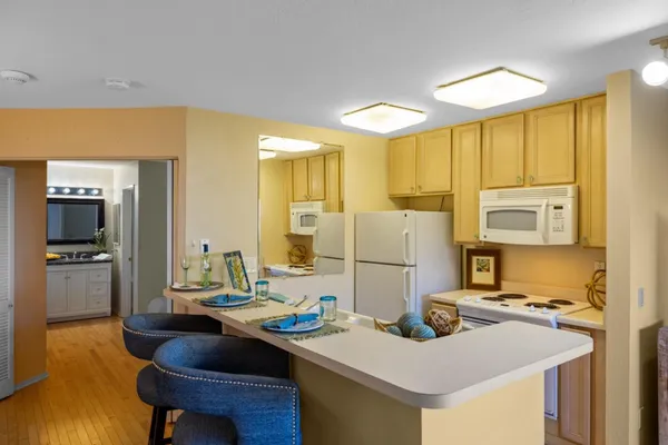 a kitchen with a sink appliances and cabinets