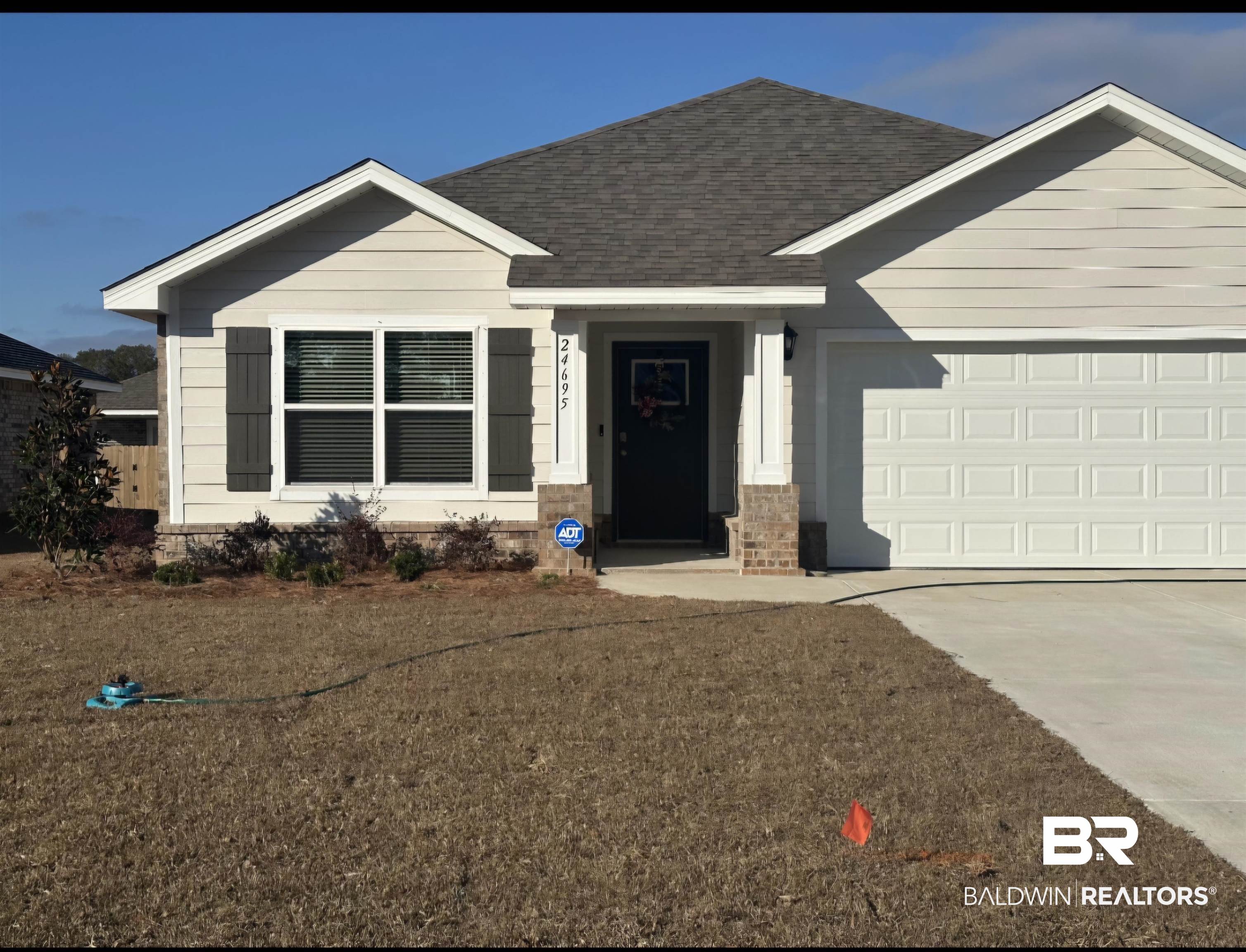 View of front of house with a front yard and a garage