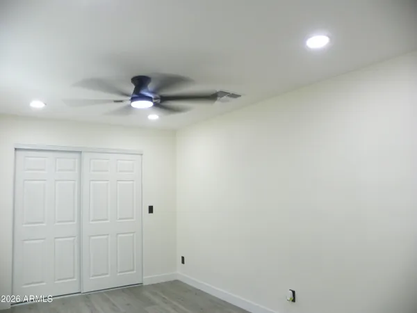 a view of a room with wooden floor and cabinet