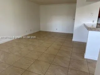 a view of a kitchen with marble wall and tiles
