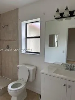 a white toilet sitting next to a bathroom sink