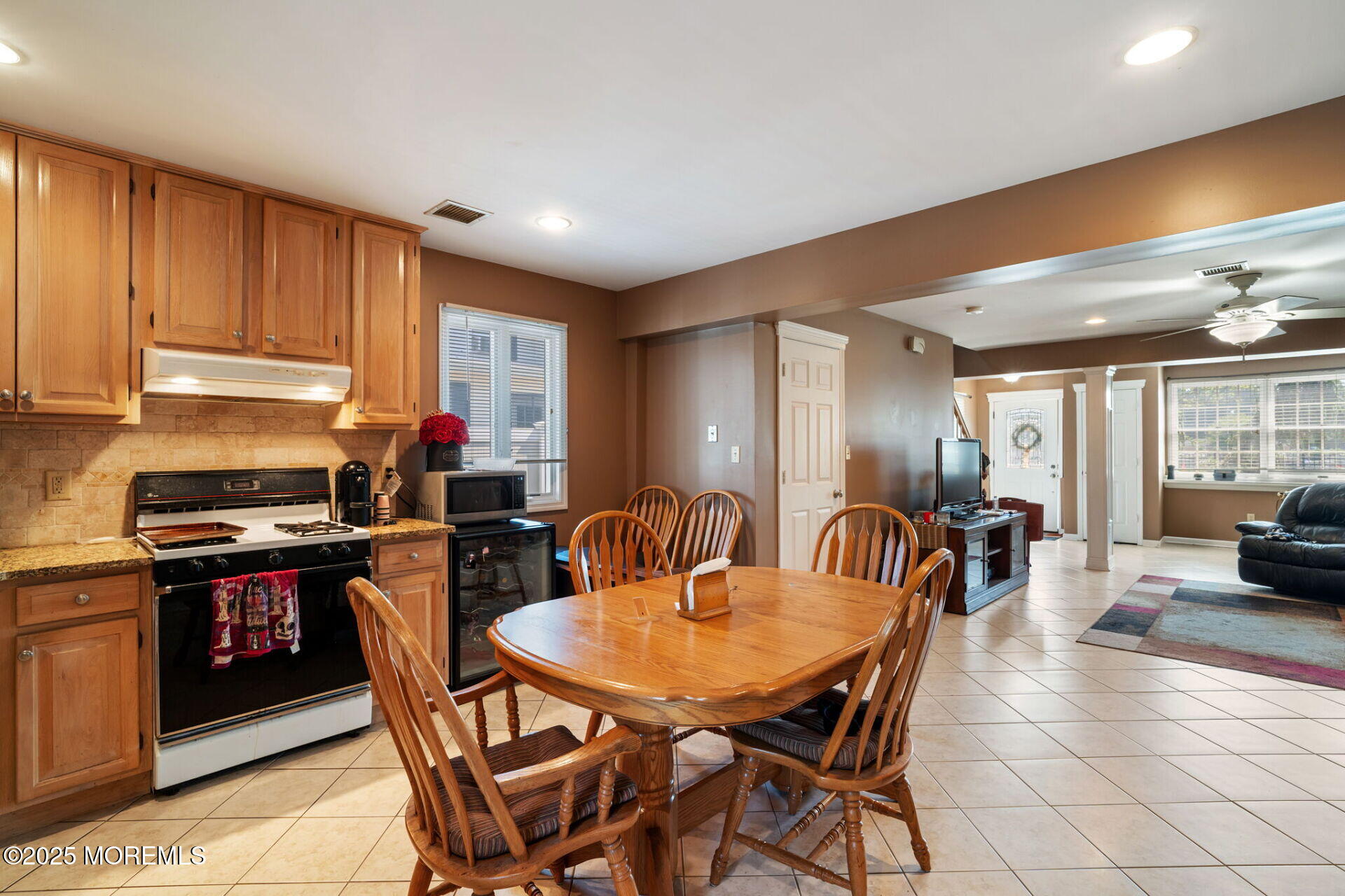 362 Broadway Keyport, NJ 07735 - Photo 9 of 18 a kitchen with stainless steel appliances wooden cabinets dining table and chairs