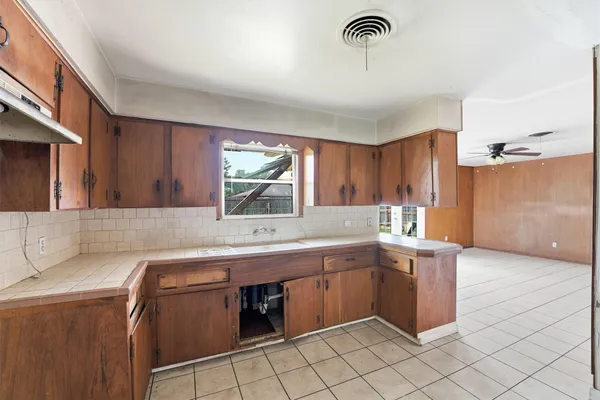 a kitchen with a sink cabinets and window