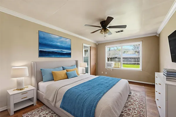 a bedroom with a large bed and a window