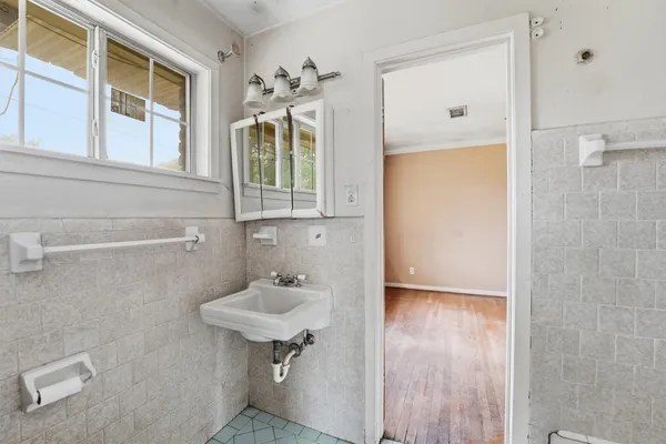 a bathroom with a sink a mirror and a shower
