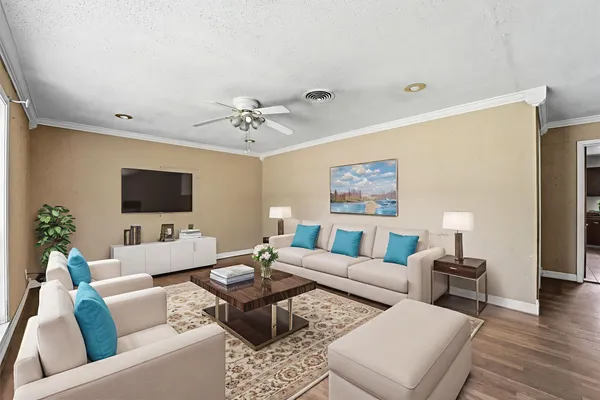 a living room with furniture and a flat screen tv