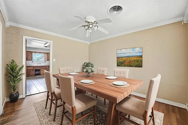 a view of a dining room with furniture and wooden floor