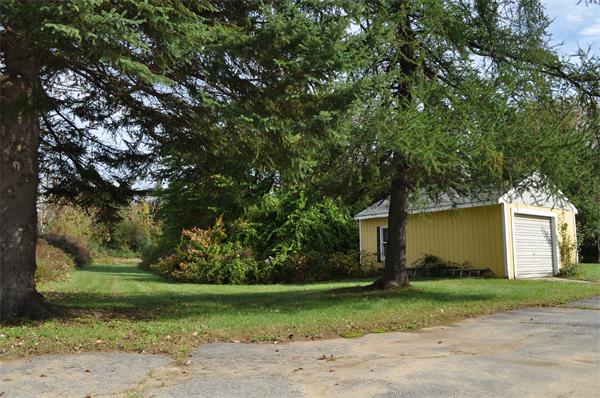 351 Ware Corner Road Oakham, MA 01068 - Photo 3 of 30 a front view of a house with a yard and a garage