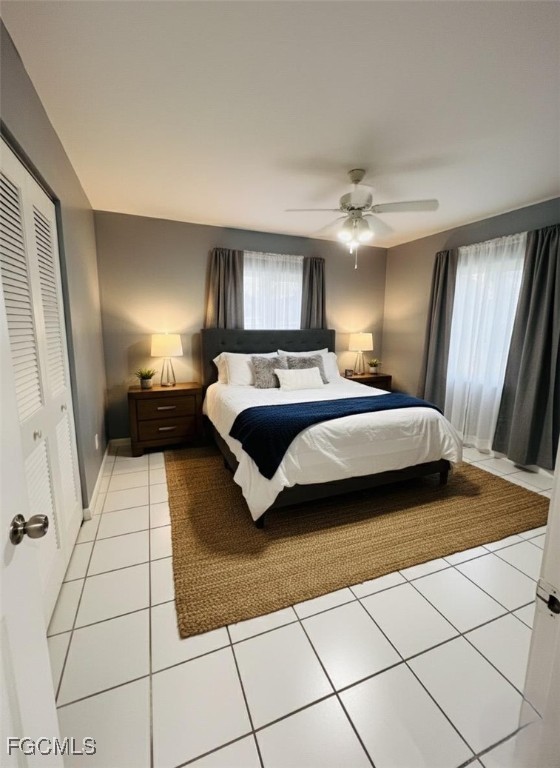 5256 Coronado Parkway Naples, FL 34116 - Photo 3 of 6 a bedroom with a large bed and a chandelier