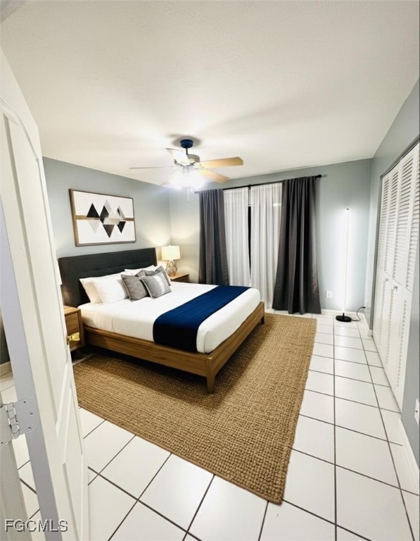 5256 Coronado Parkway Naples, FL 34116 - Photo 4 of 6 a bedroom with a large bed and a chandelier