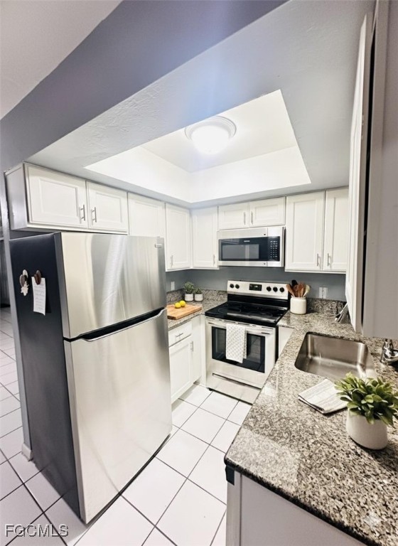 5256 Coronado Parkway Naples, FL 34116 - Photo 6 of 6 a kitchen with a refrigerator a stove a microwave and cabinets