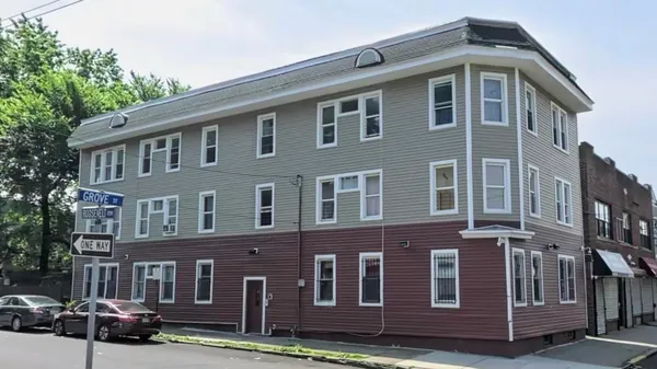 a front view of a building with garden