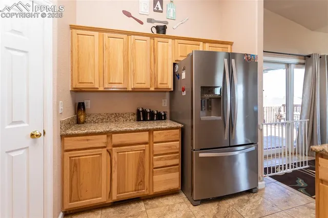 a kitchen with granite countertop a sink and cabinets