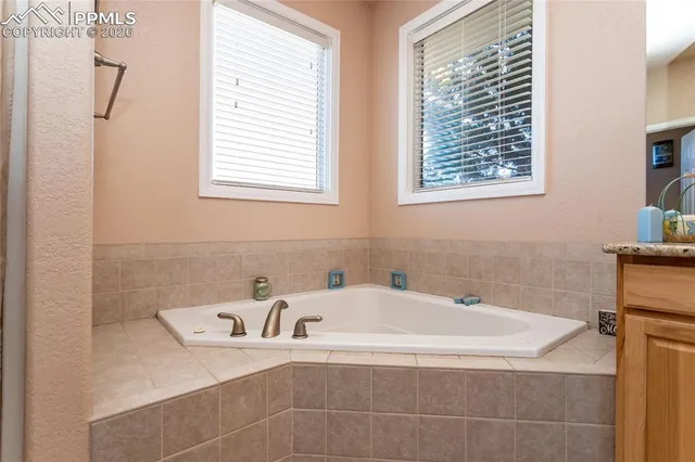 a view of walk in closet with clothes