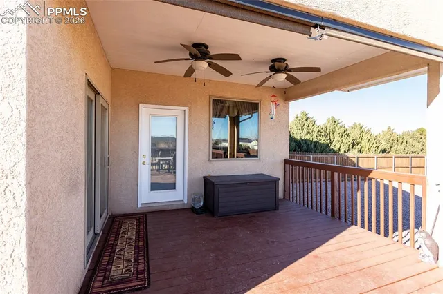 a view of a balcony with wooden floor and seating space