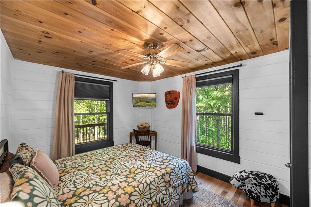 832 Scenic Mountain View Road Blue Ridge, GA 30513 - Photo 13 of 56 a bedroom with a bed and a large window with the potted plants