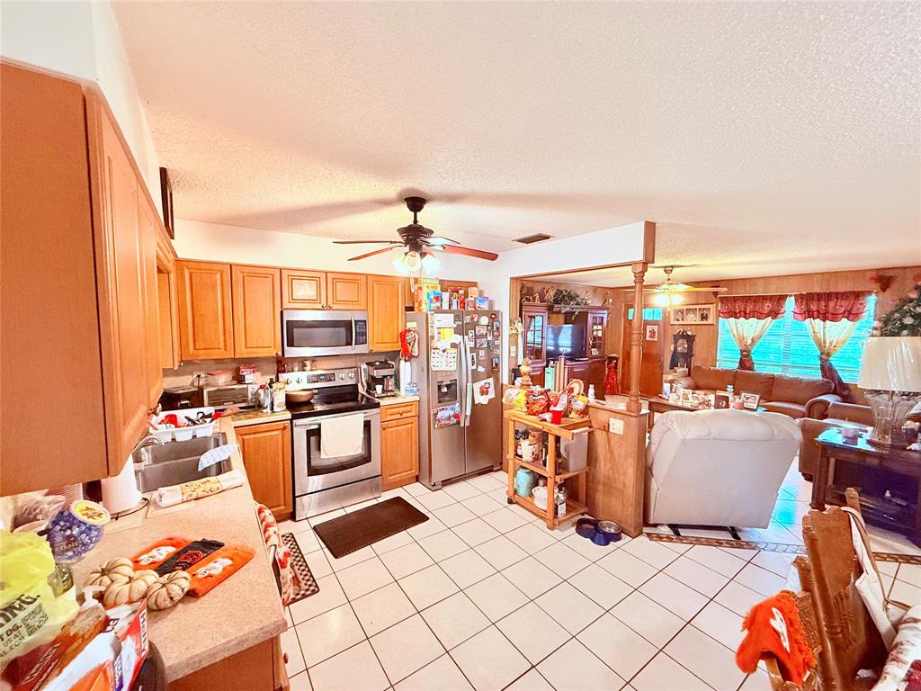 393 Southwest 72nd Terrace Okeechobee, FL 34974 - Photo 11 of 21 a large room with a lot of stuff and furniture