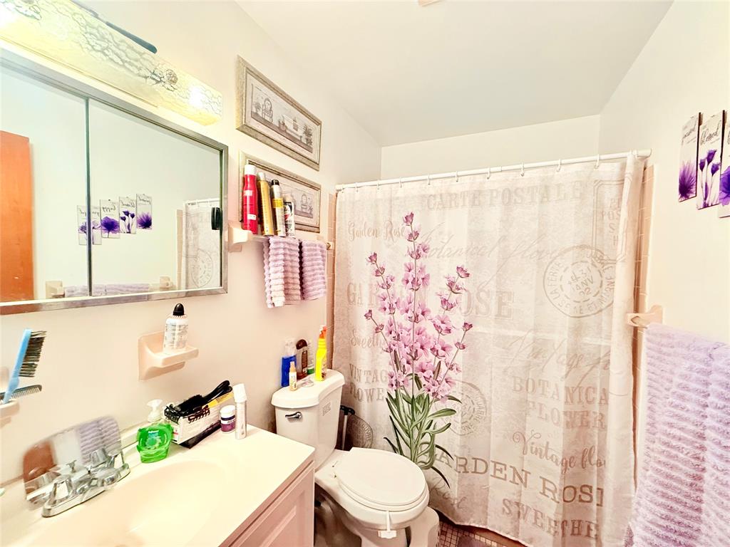 393 Southwest 72nd Terrace Okeechobee, FL 34974 - Photo 17 of 21 a bathroom with a sink a toilet and a shower curtain