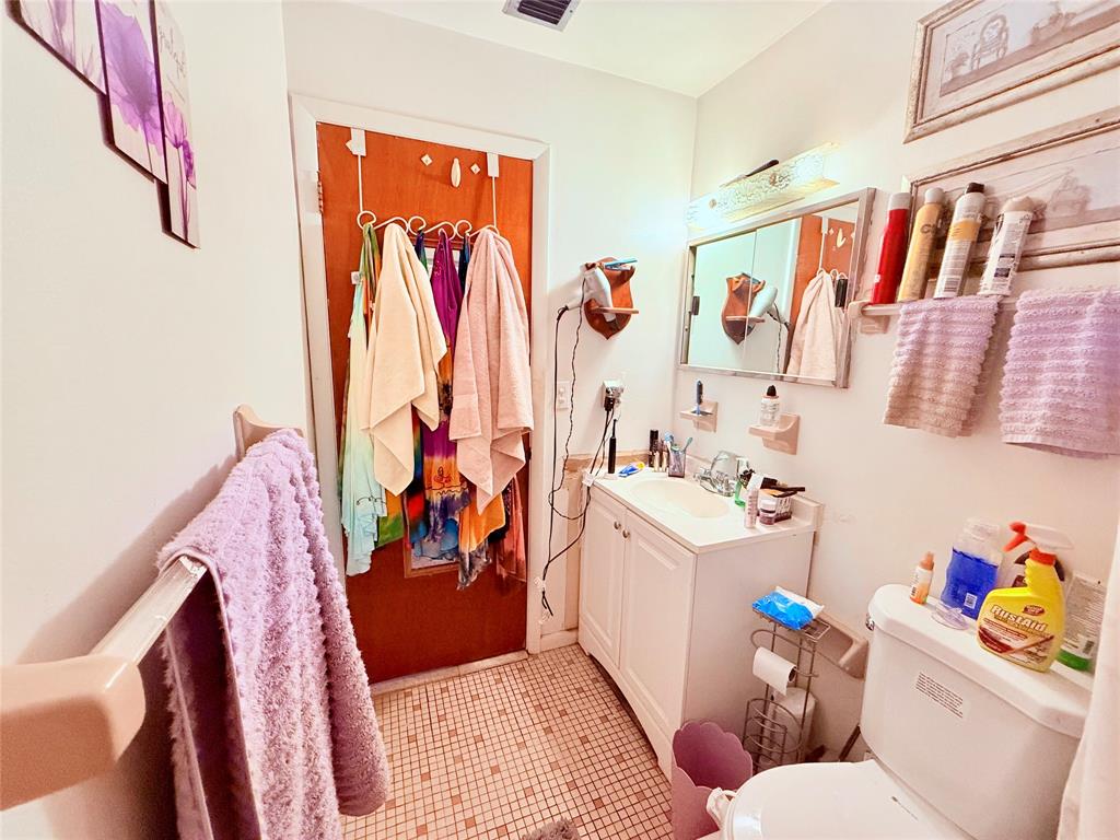 393 Southwest 72nd Terrace Okeechobee, FL 34974 - Photo 18 of 21 a bathroom with a sink toilet and shower curtain