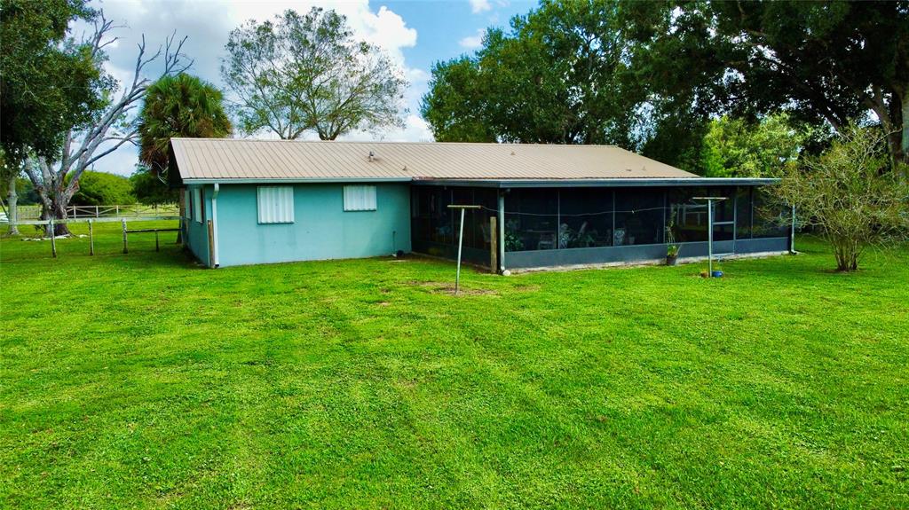 393 Southwest 72nd Terrace Okeechobee, FL 34974 - Photo 6 of 21 a view of a house with a yard and sitting area