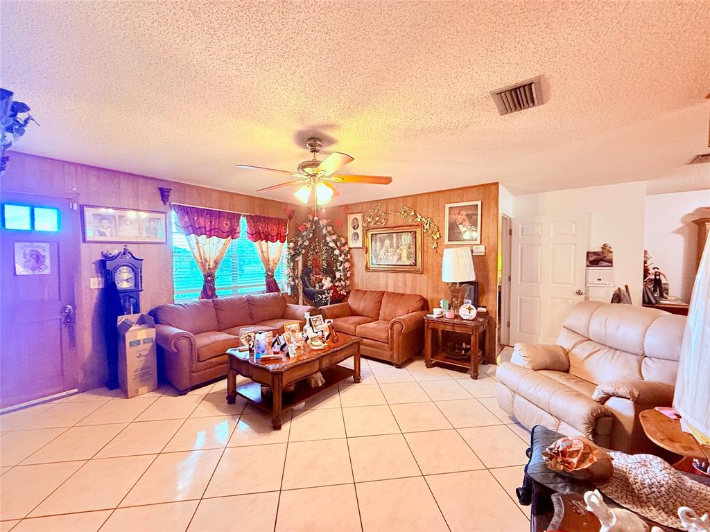 393 Southwest 72nd Terrace Okeechobee, FL 34974 - Photo 8 of 21 a living room with furniture and a flat screen tv
