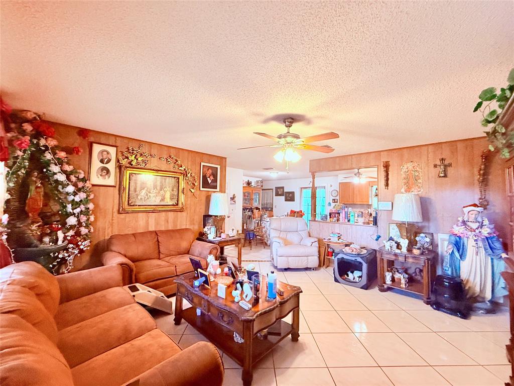 393 Southwest 72nd Terrace Okeechobee, FL 34974 - Photo 9 of 21 a living room with furniture a rug and a chandelier