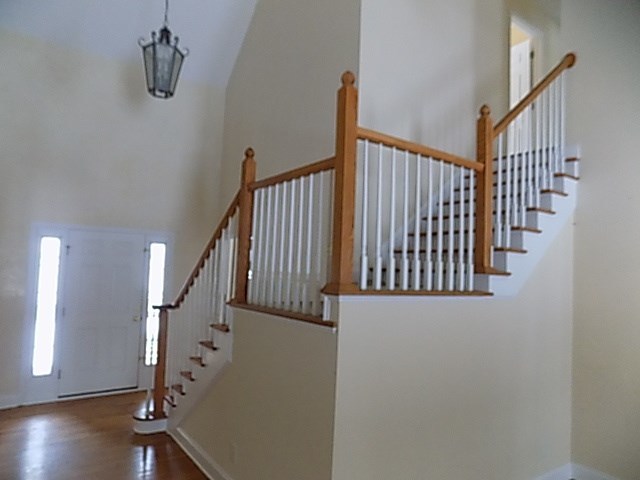 443 Annies Path Gray, GA 31032 - Photo 5 of 23 a view of staircase with railing and a chandelier