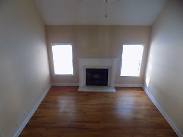 443 Annies Path Gray, GA 31032 - Photo 6 of 23 an empty room with wooden floor a fireplace and windows