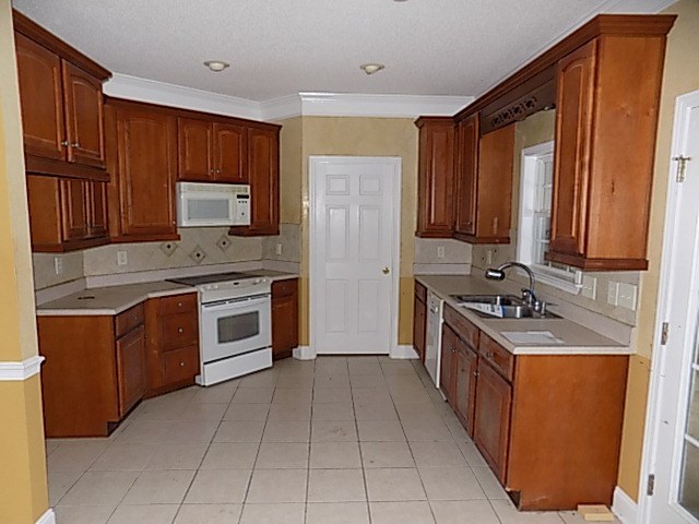 443 Annies Path Gray, GA 31032 - Photo 7 of 23 a kitchen with stainless steel appliances granite countertop a stove top oven a sink dishwasher and a refrigerator with wooden cabinets