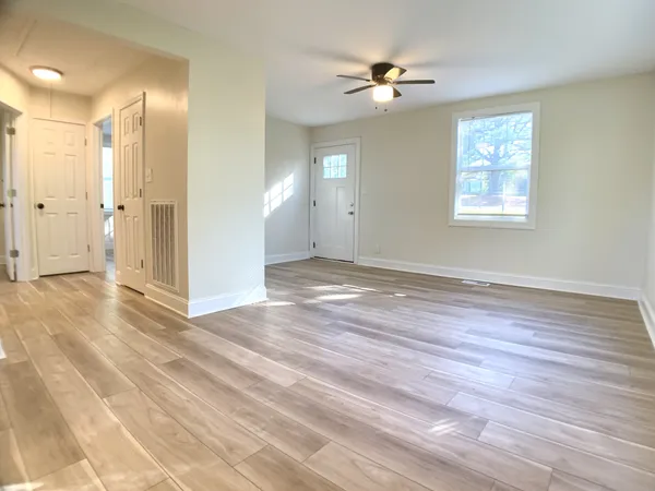 wooden floor in an empty room with a window