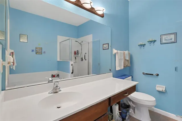 a bathroom with a sink a toilet and mirror