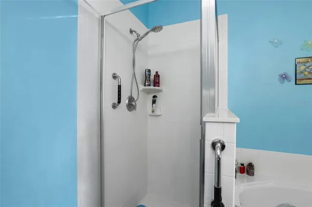 a bathroom with a bathtub and shower