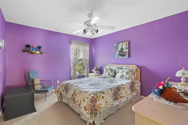 a bedroom with a bed mirror and a window