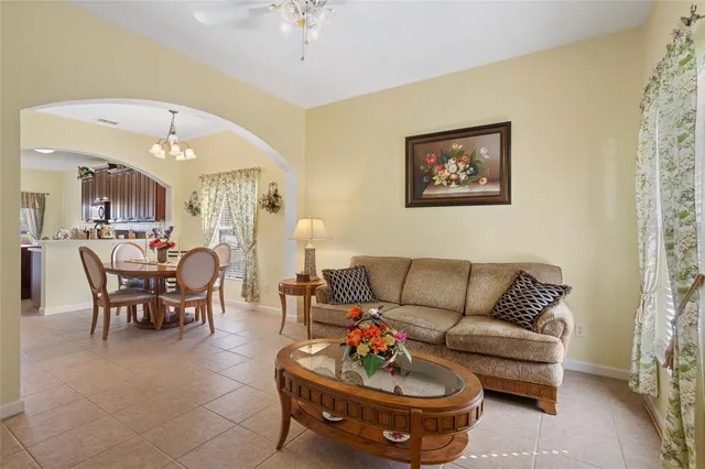 a living room with furniture and a chandelier
