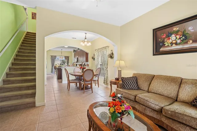 a living room with furniture and flowers