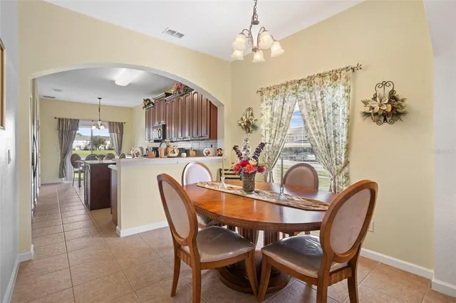 a view of a dining room with furniture and chandelier