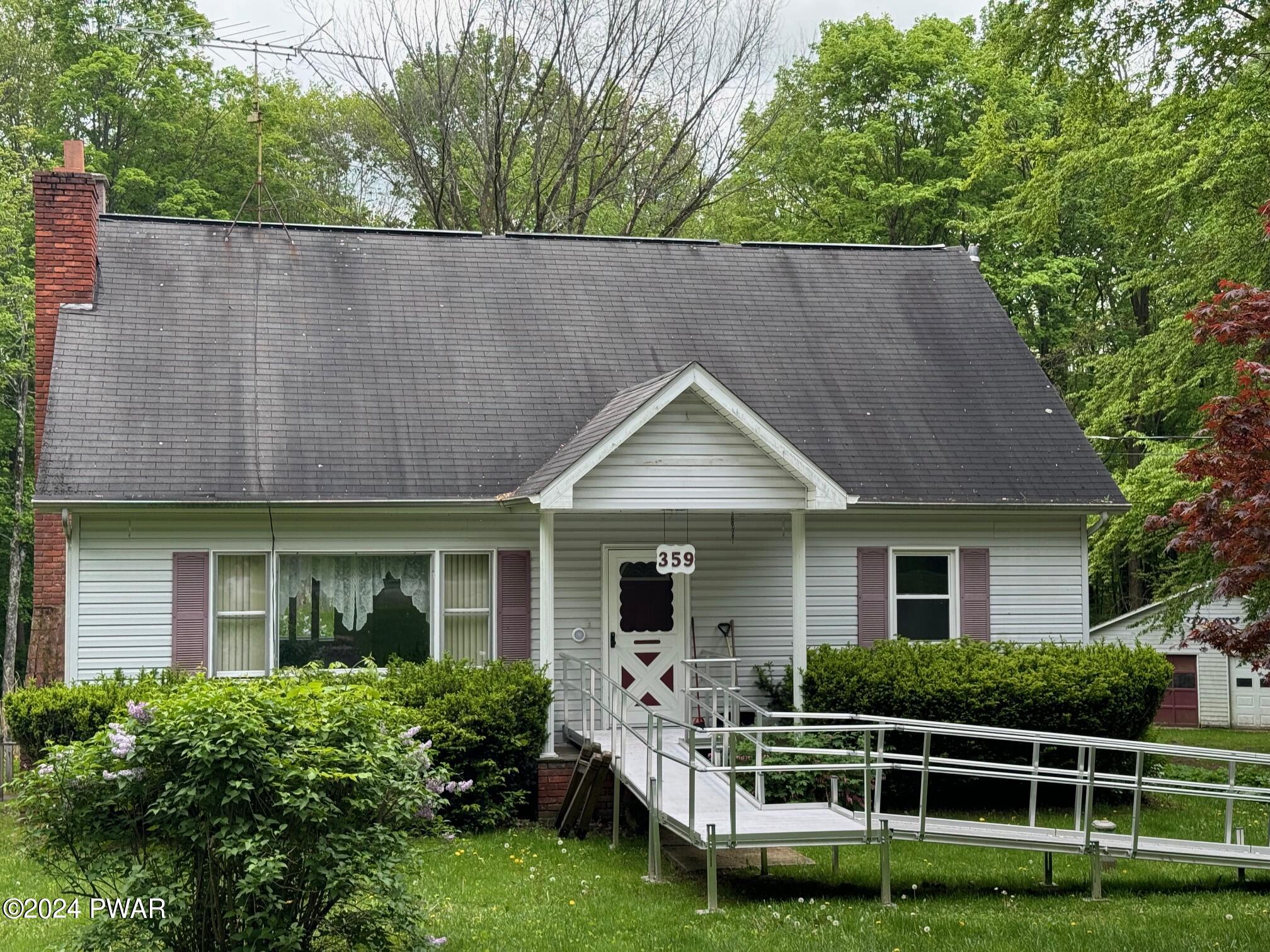 359 Canaan Road Waymart, PA 18472 - Photo 32 of 32 a front view of a house with garden