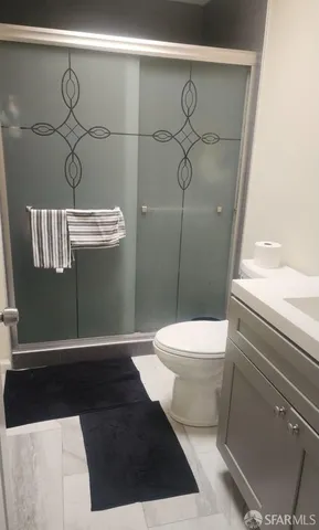 a bathroom with a toilet and a shower