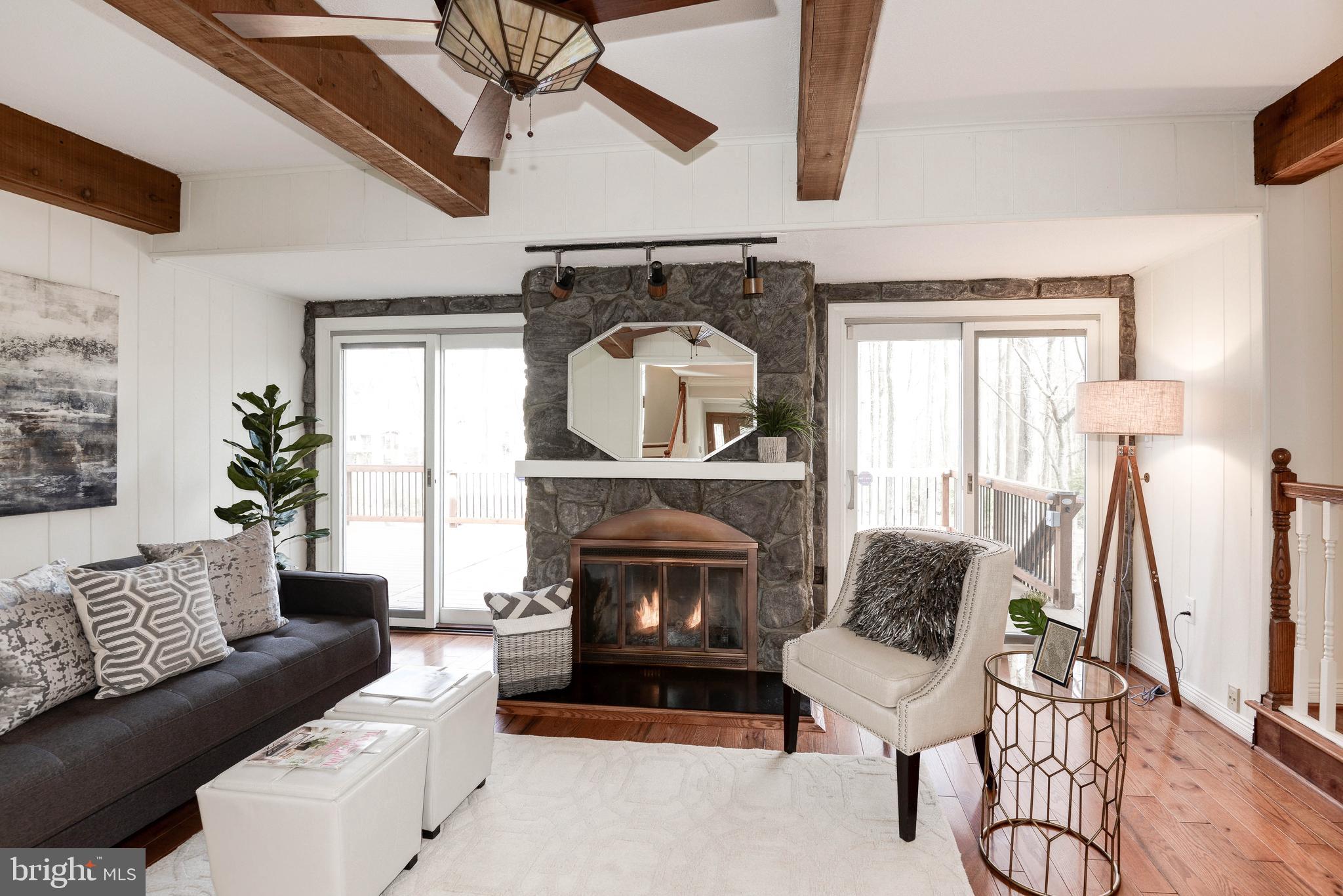 11805 Blue Spruce Road Reston, VA 20191 - Photo 20 of 74 a living room with furniture a fireplace and a flat screen tv