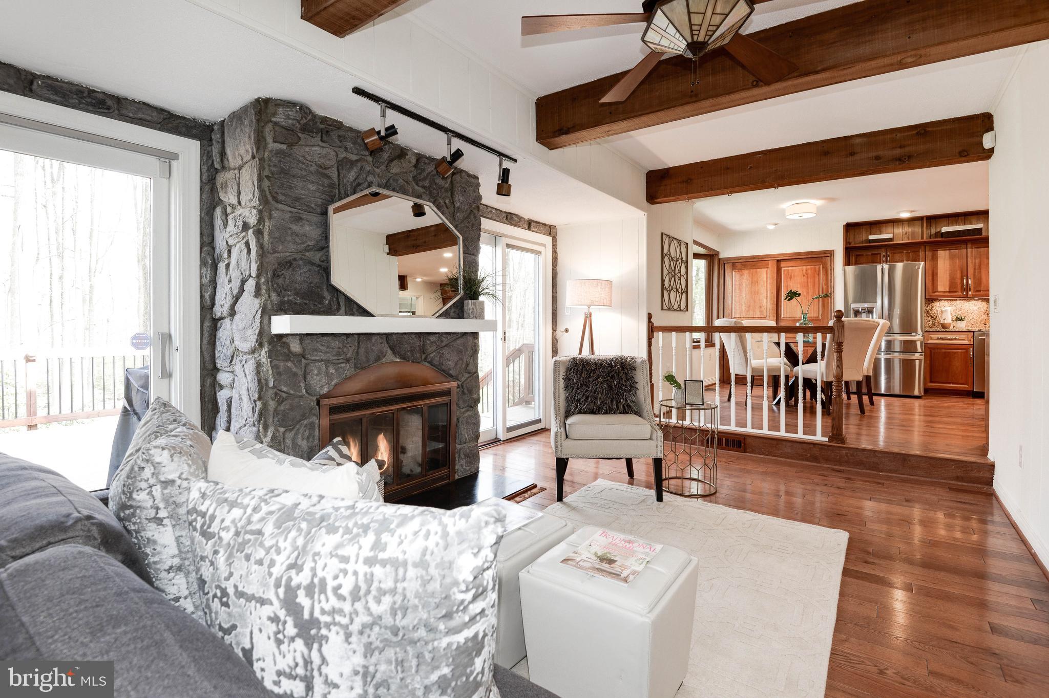 11805 Blue Spruce Road Reston, VA 20191 - Photo 21 of 74 a living room with furniture a fireplace and a table