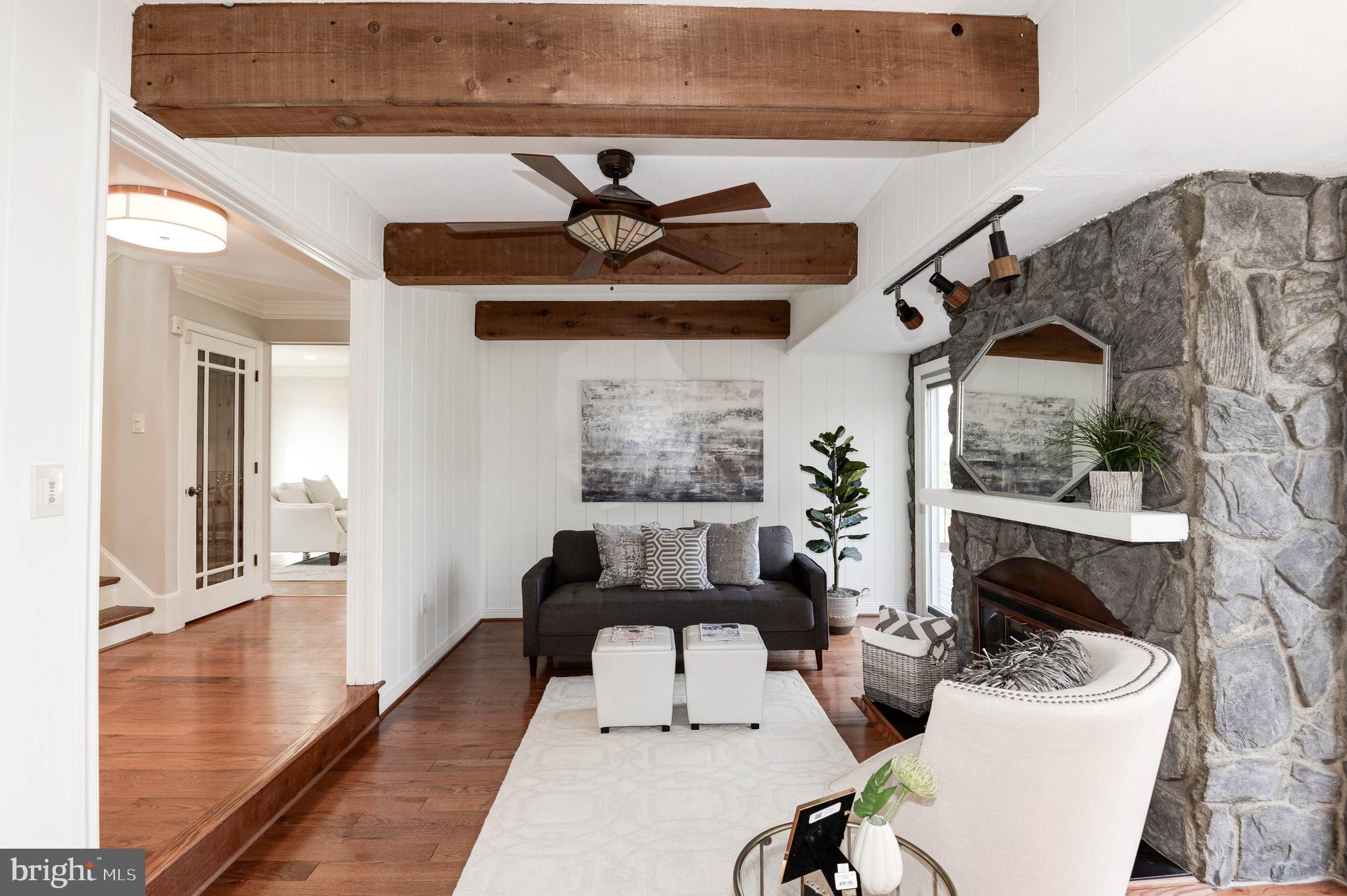 11805 Blue Spruce Road Reston, VA 20191 - Photo 22 of 74 a living room with furniture a fireplace and wooden floor