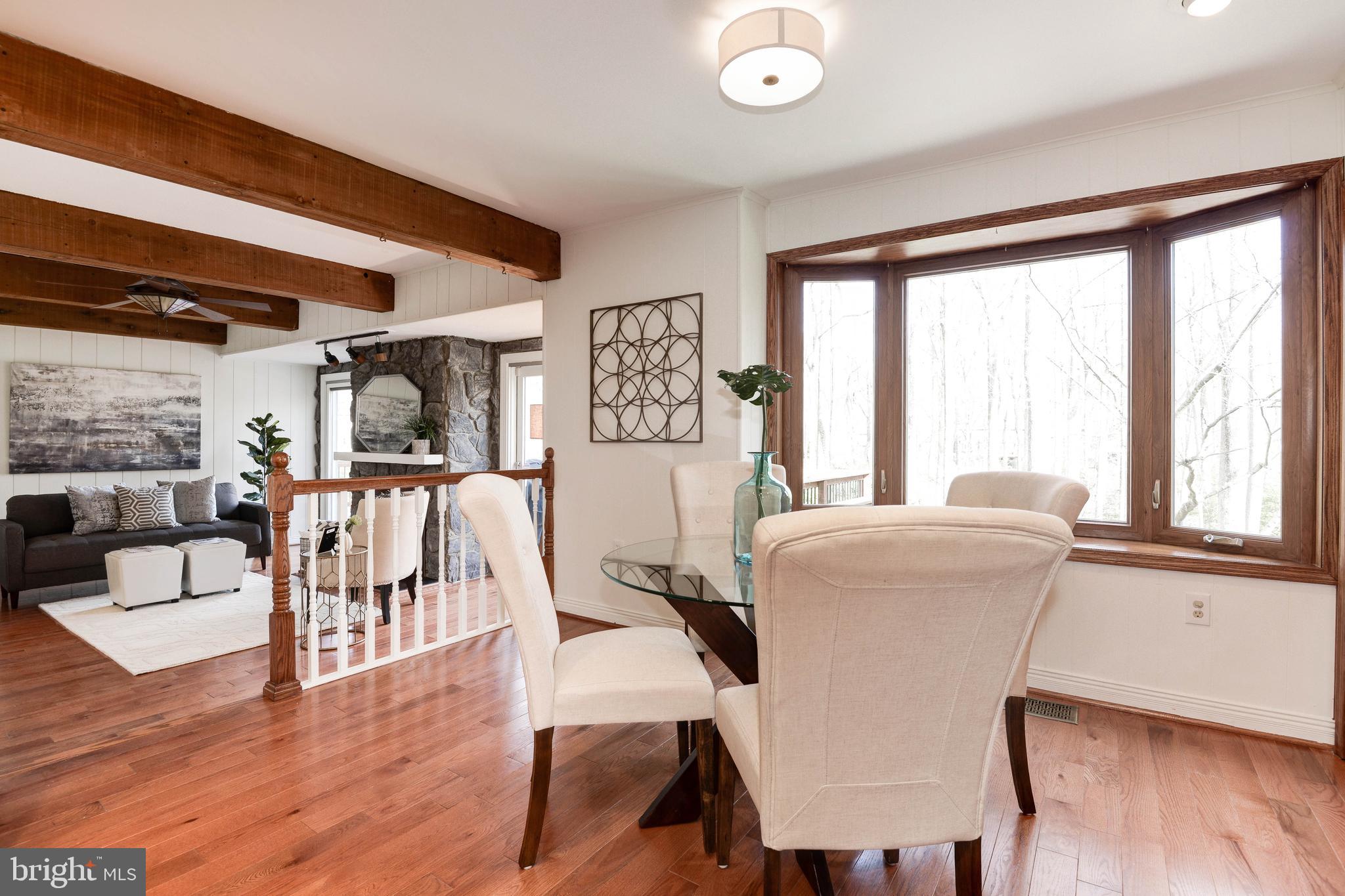 11805 Blue Spruce Road Reston, VA 20191 - Photo 25 of 74 a dining room with wooden floor and large windows