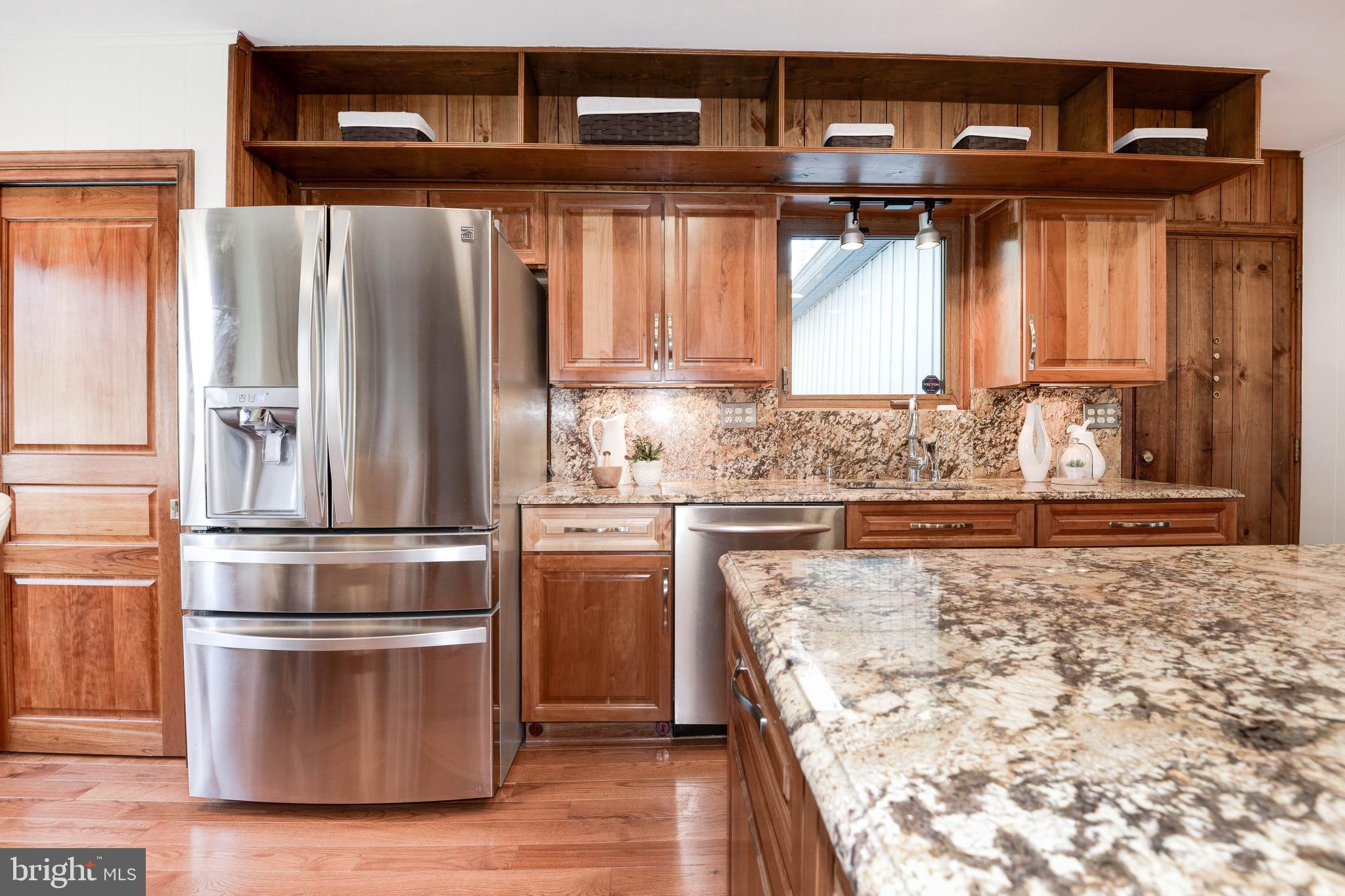 11805 Blue Spruce Road Reston, VA 20191 - Photo 27 of 74 a kitchen with granite countertop a refrigerator and a stove