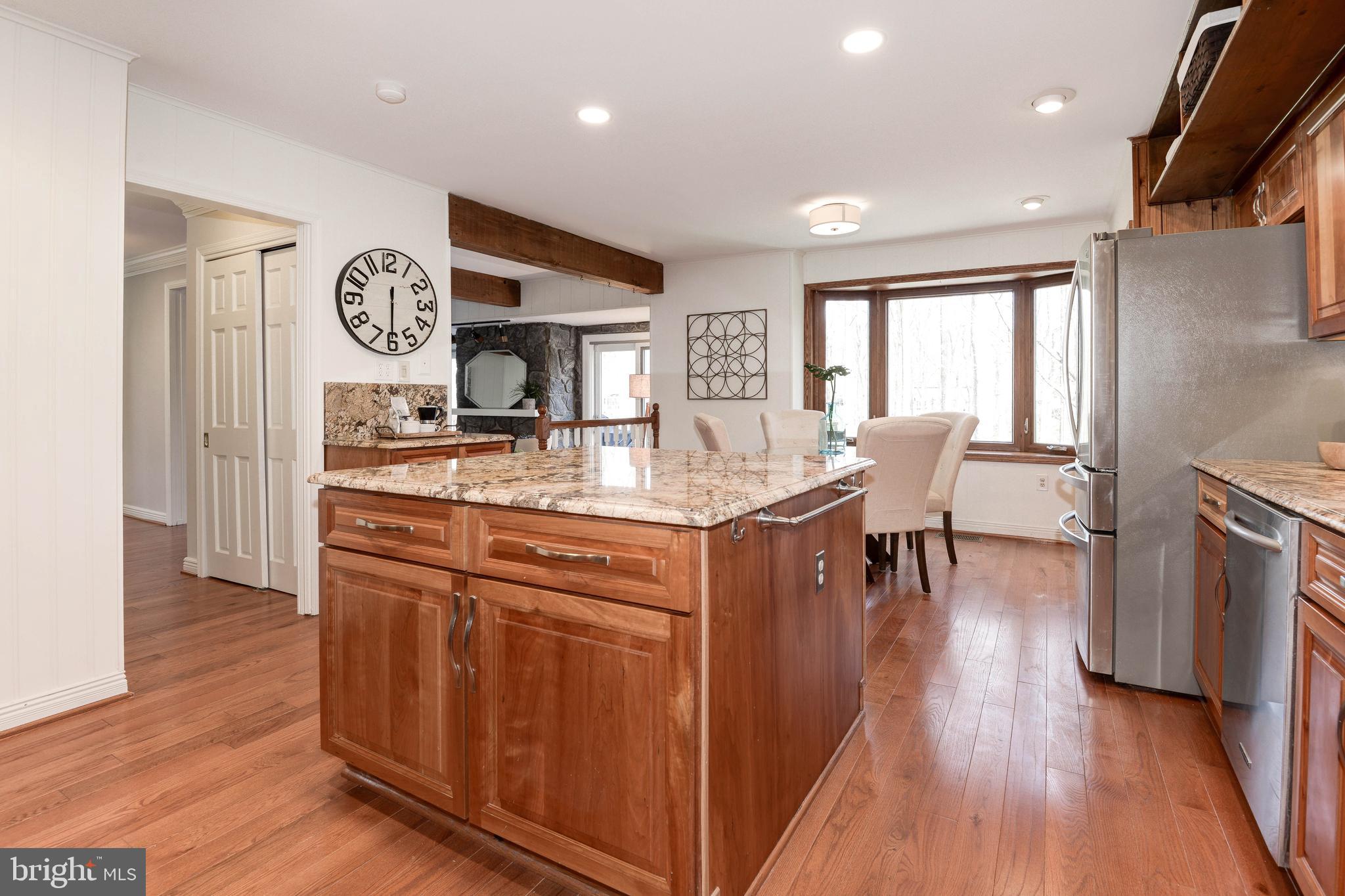 11805 Blue Spruce Road Reston, VA 20191 - Photo 32 of 74 a living room with stainless steel appliances granite countertop furniture wooden floor and a view of kitchen