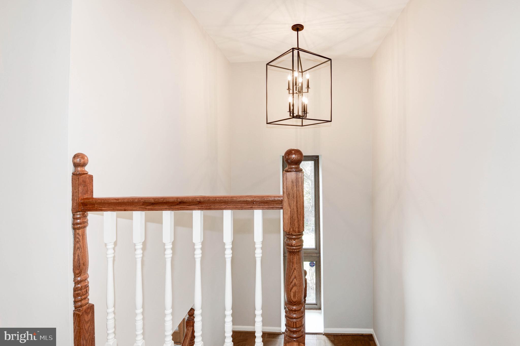 11805 Blue Spruce Road Reston, VA 20191 - Photo 36 of 74 a view of a hallway with wooden floor and staircase