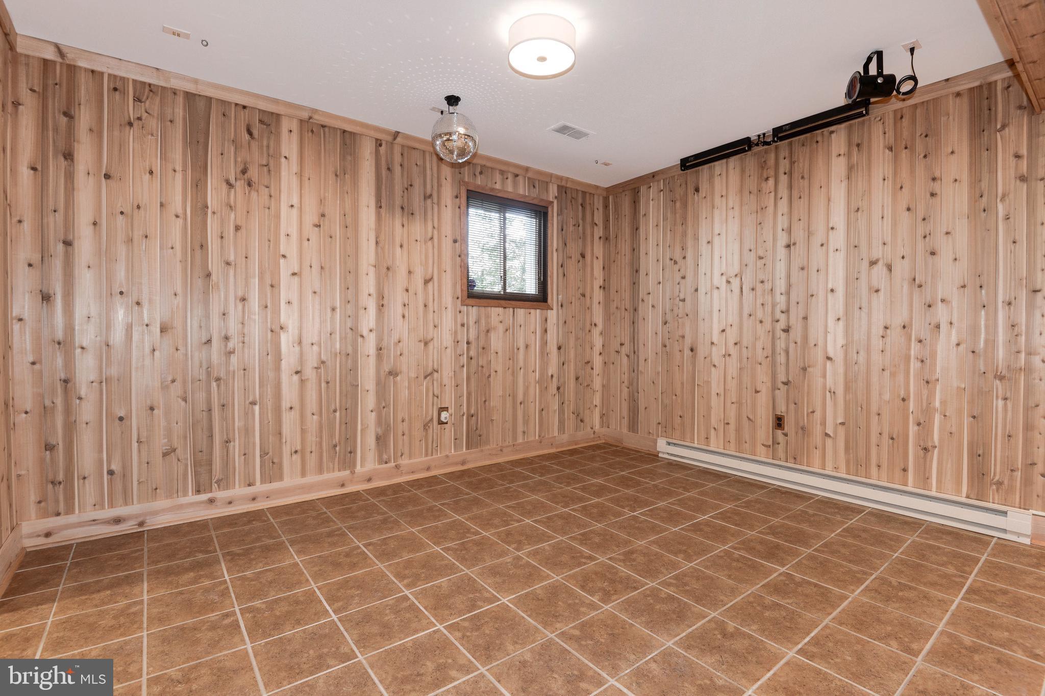 11805 Blue Spruce Road Reston, VA 20191 - Photo 56 of 74 a view of an empty room with wooden walls