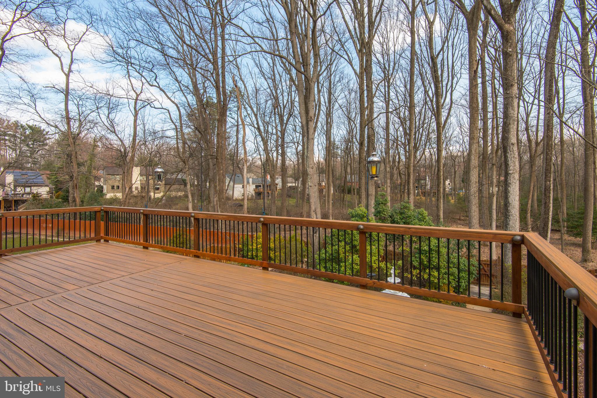 11805 Blue Spruce Road Reston, VA 20191 - Photo 63 of 74 a view of a balcony with wooden floor and fence