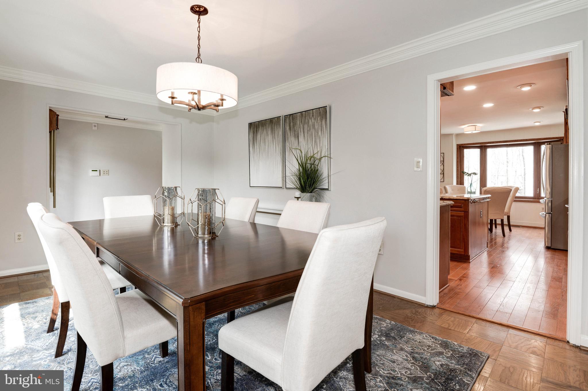 11805 Blue Spruce Road Reston, VA 20191 - Photo 10 of 74 a view of a dining room with furniture wooden floor and chandelier