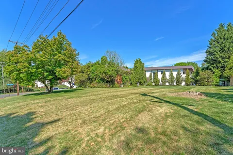 a view of a field of grass and trees